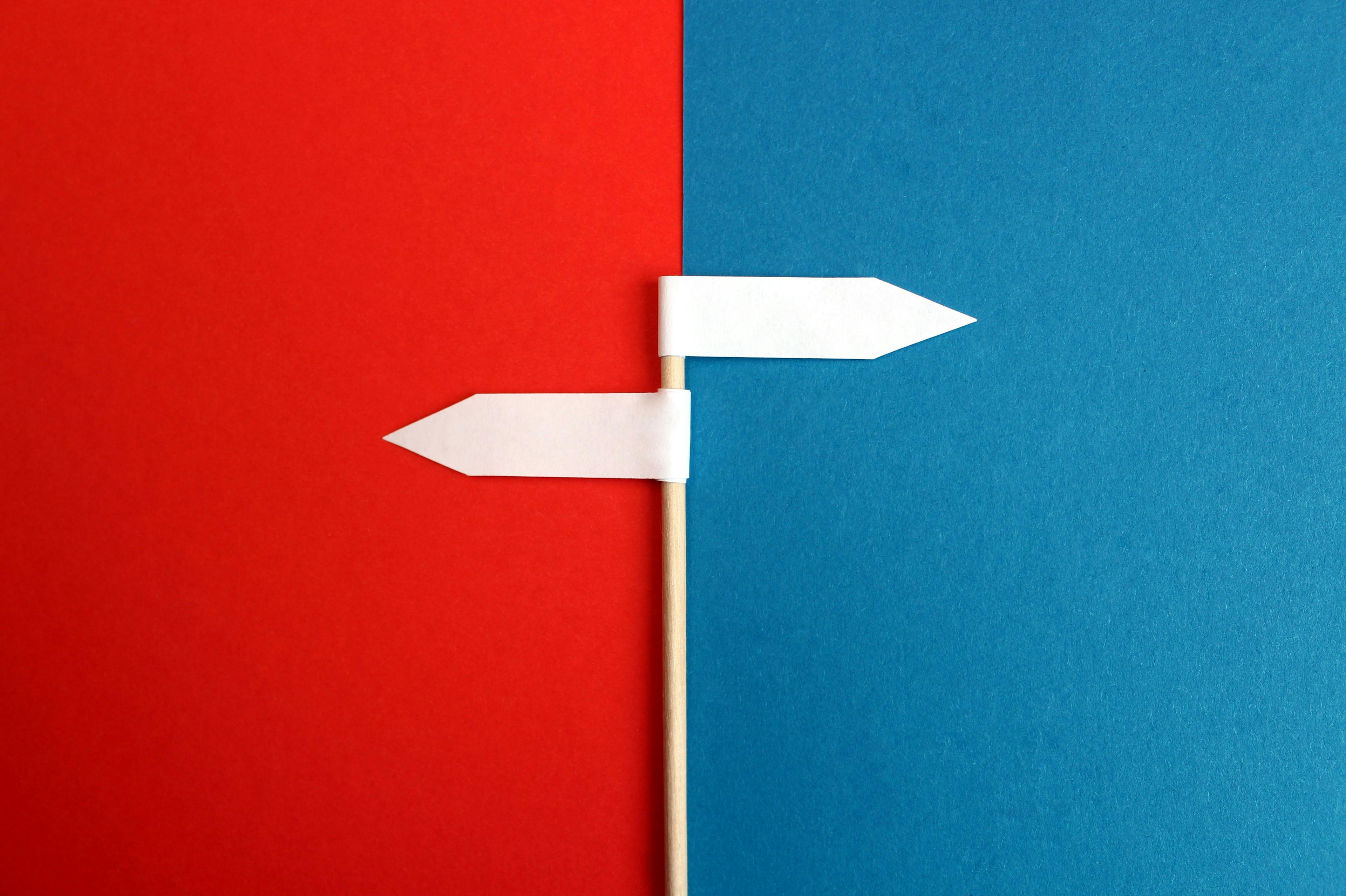 a blue and red background with a white flag on it that points in either direction
